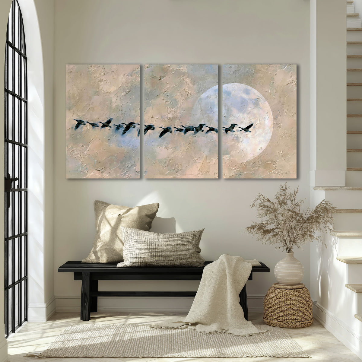 Geese flying across the moon painting 3 piece canvas wall art in an entryway above a bench