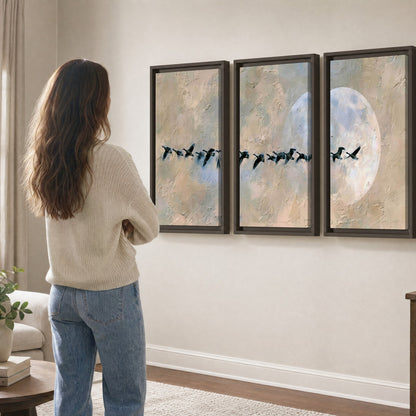 Geese flying across the moon painting 3 piece framed canvas in a living room