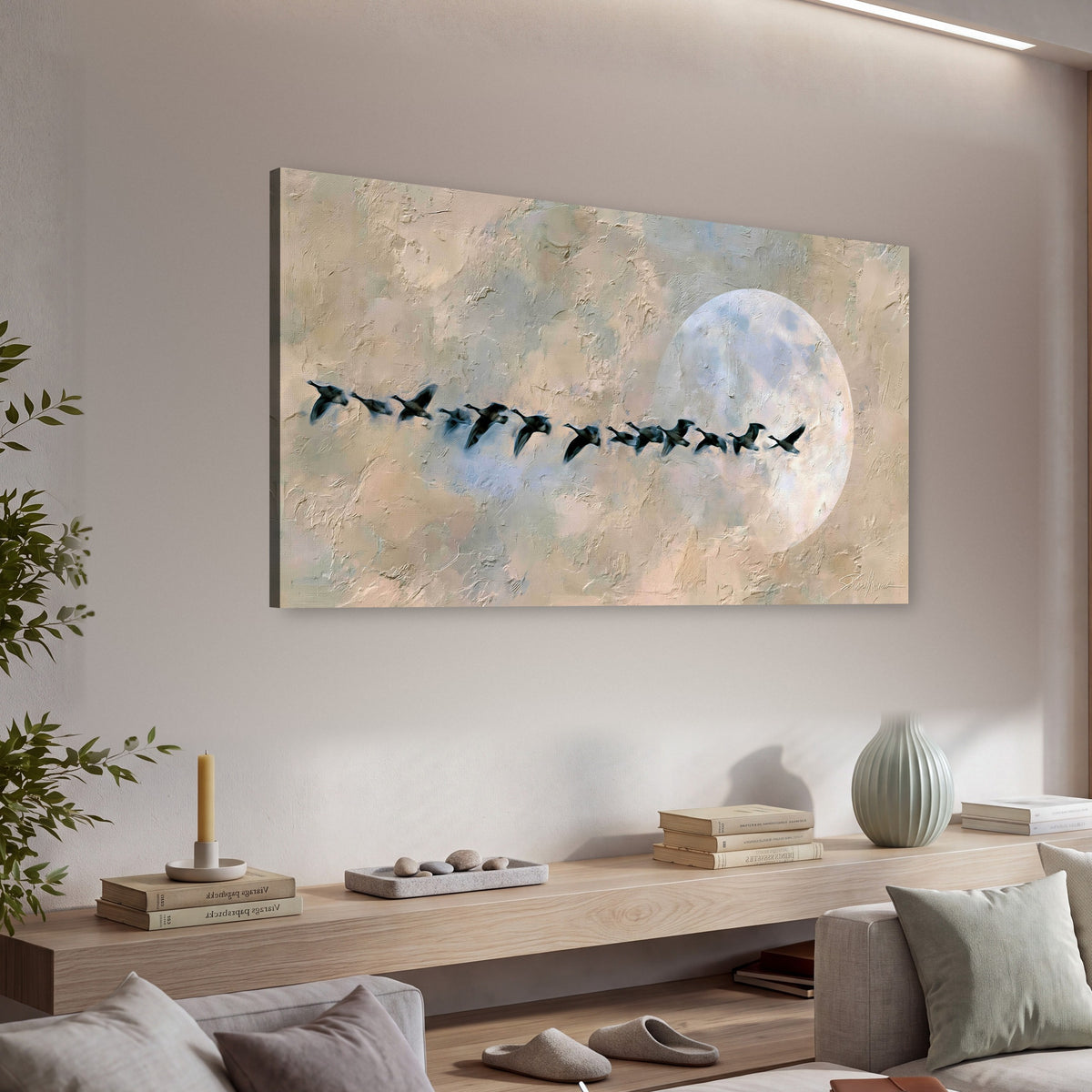 Geese flying across the moon painting canvas wall art in a living room above a console