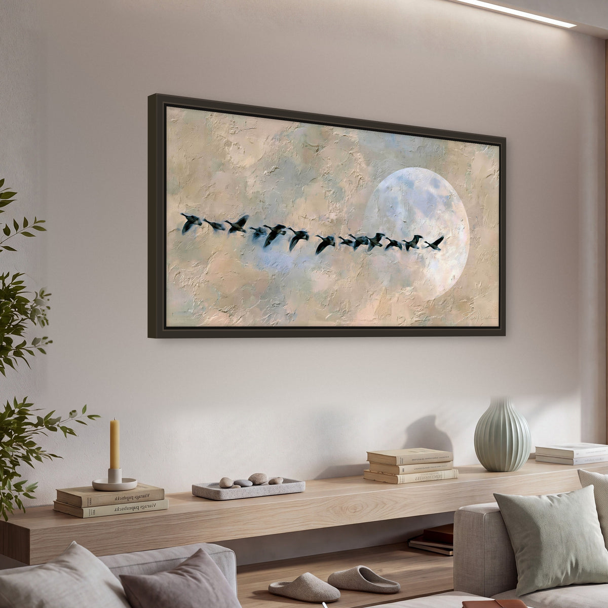 Geese flying across the moon painting framed canvas wall art in a living room above a console