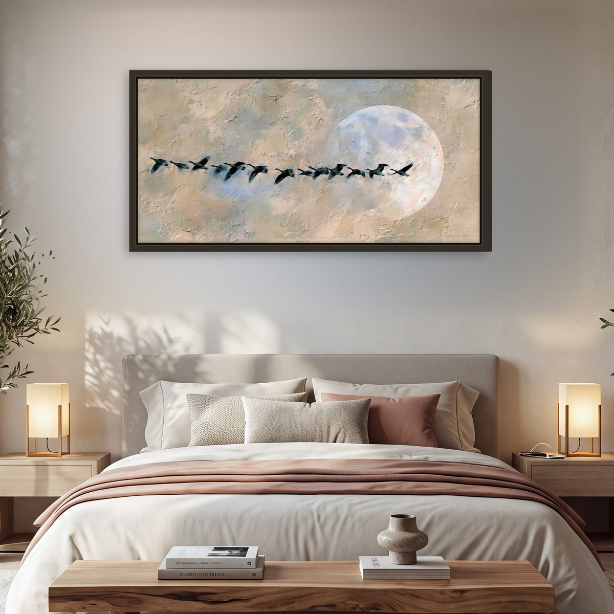 Geese flying across the moon painting framed canvas wall art in a bedroom above the bed