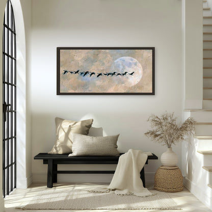 Geese flying across the moon painting framed canvas wall art in an entryway above a bench