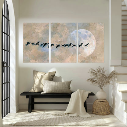 Geese flying across the moon painting set of 3 poster prints in an entryway above a bench