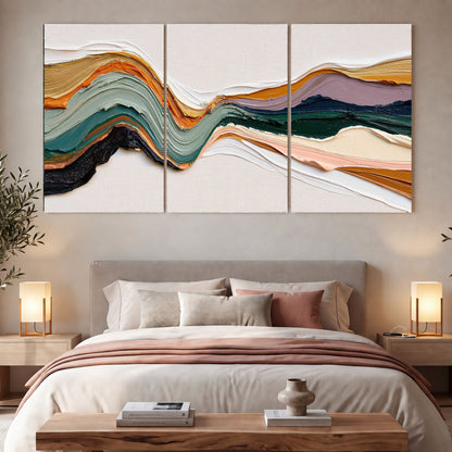 Textured abstract waves painting 3 piece canvas wall art in a bedroom above the bed