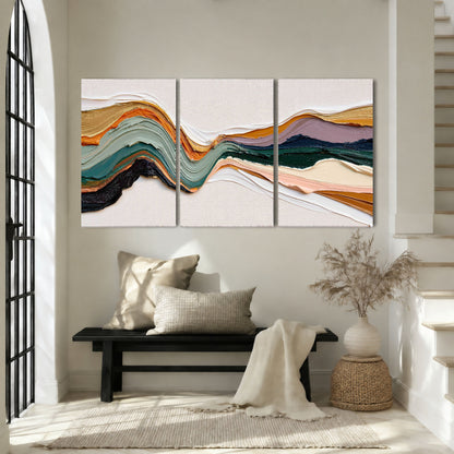 Textured abstract waves painting 3 piece canvas wall art in an entryway above a bench
