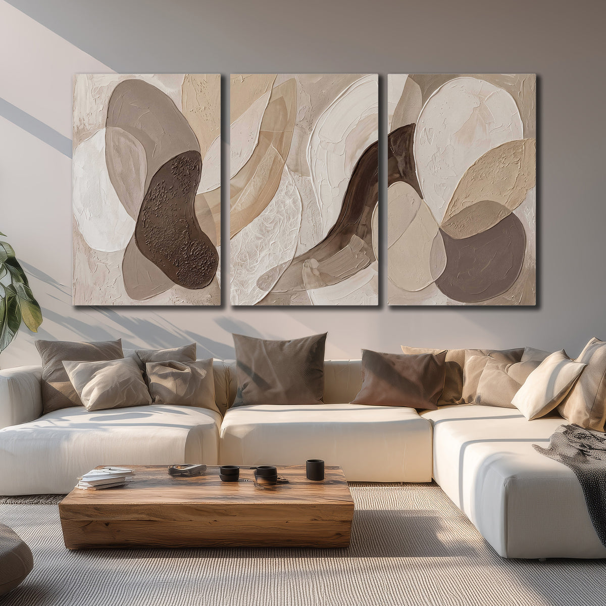 Layered organic shapes in taupe, cream and brown 3 piece canvas wall art displayed in a living room