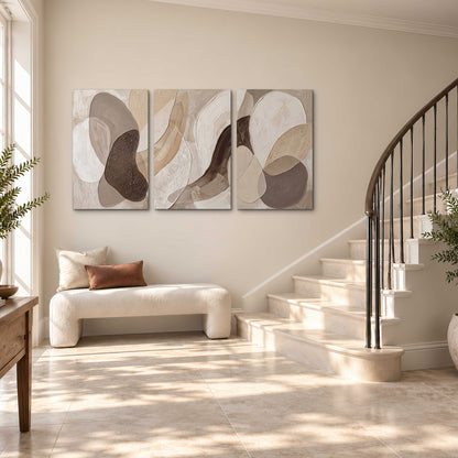 Layered organic shapes in taupe, cream and brown 3 piece canvas wall art styled in an interior