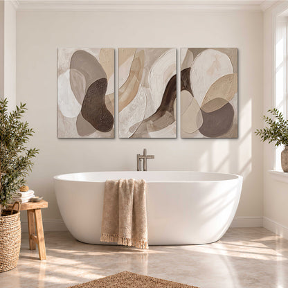 Layered organic shapes in taupe, cream and brown 3 piece canvas wall art styled in an interior