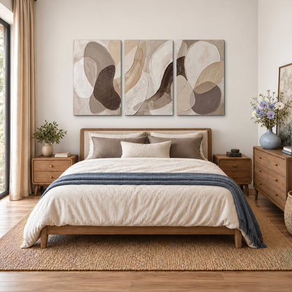 Layered organic shapes in taupe, cream and brown 3 piece canvas wall art styled in an interior