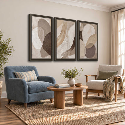Layered organic shapes in taupe, cream and brown 3 piece framed canvas wall art styled in an interior