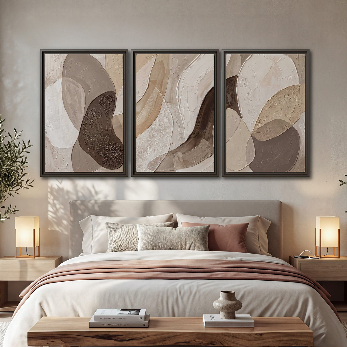 Layered organic shapes in taupe, cream and brown 3 piece framed canvas wall art displayed in a bedroom