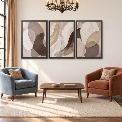 Layered organic shapes in taupe, cream and brown 3 piece framed canvas wall art styled in an interior