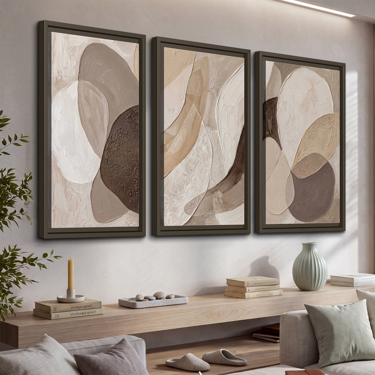 Layered organic shapes in taupe, cream and brown 3 piece framed canvas wall art displayed in a console