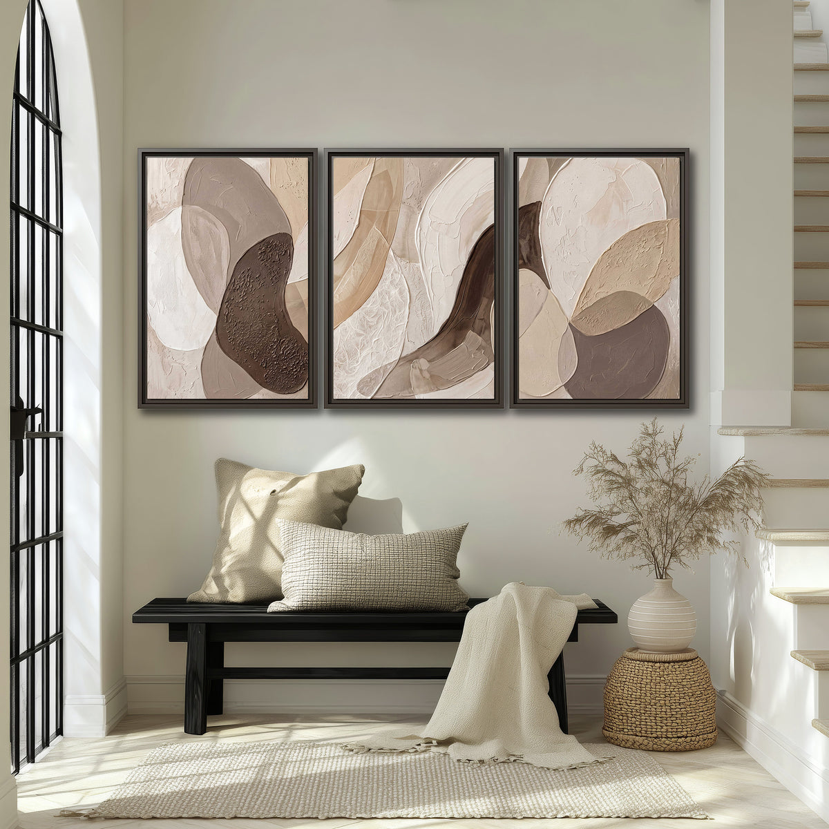 Layered organic shapes in taupe, cream and brown 3 piece framed canvas wall art displayed in a entryway