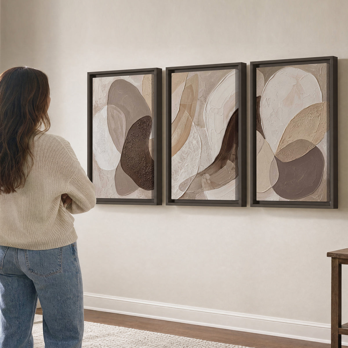 Layered organic shapes in taupe, cream and brown 3 piece framed canvas wall art three panel arrangement on a wall