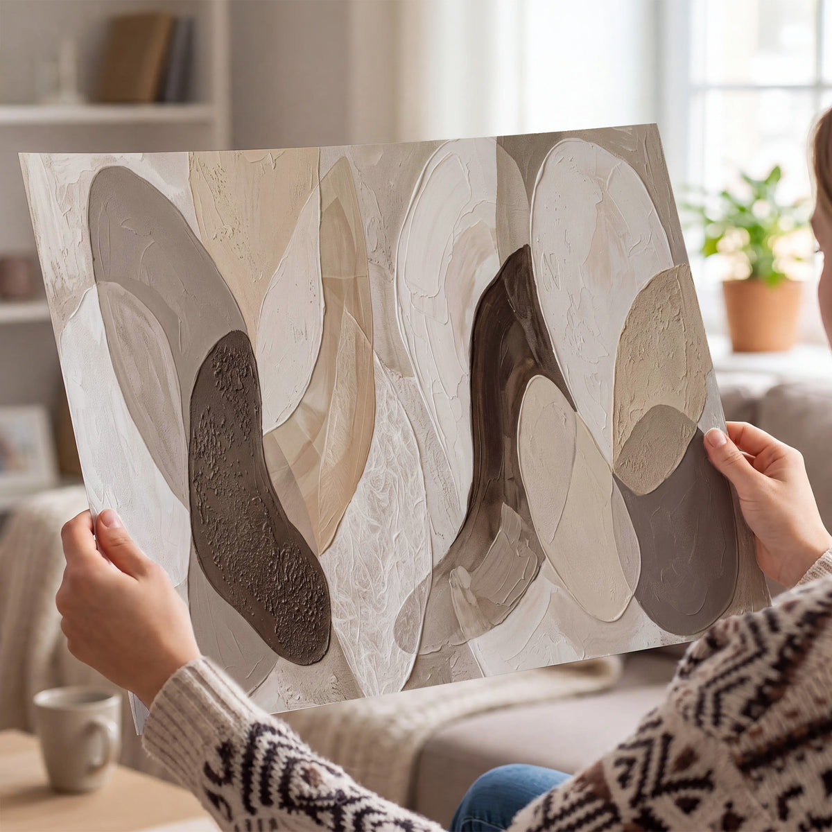 Layered organic shapes in taupe, cream and brown single poster print held in hands