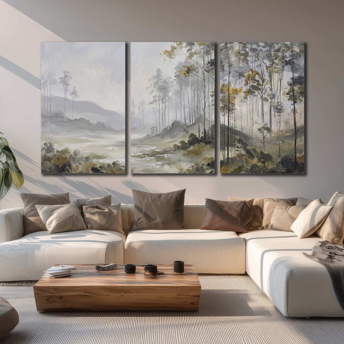 Misty woodland stream with gray trees, muted olive foliage and distant hazy hills 3 piece canvas wall art displayed in a living room