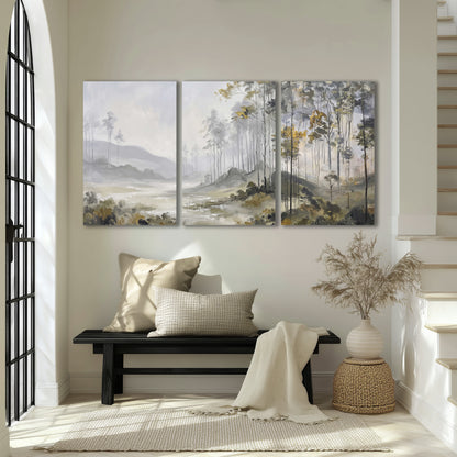 Misty woodland stream with gray trees, muted olive foliage and distant hazy hills 3 piece canvas wall art displayed in a entryway