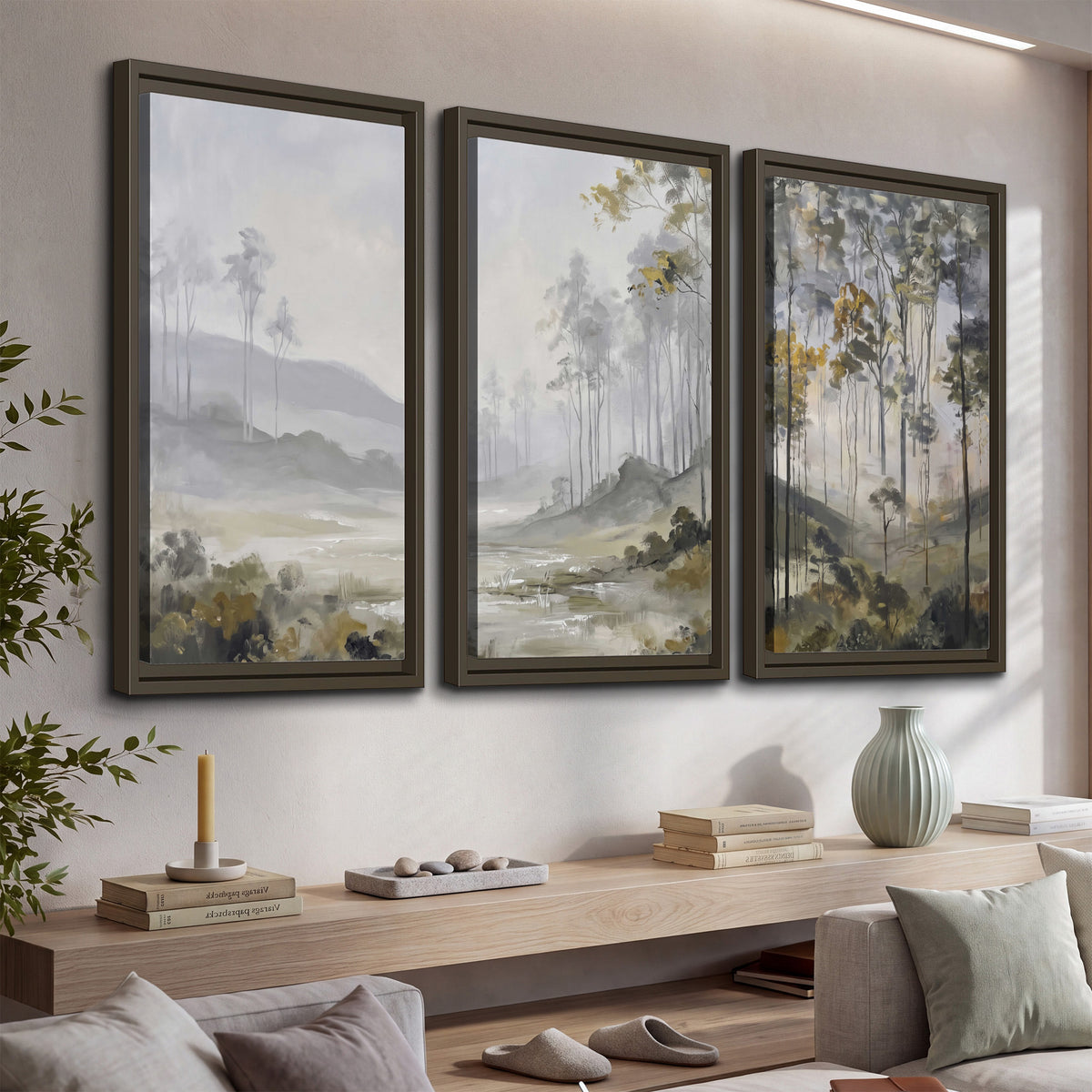 Misty woodland stream with gray trees, muted olive foliage and distant hazy hills 3 piece framed canvas wall art displayed in a console