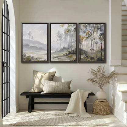 Misty woodland stream with gray trees, muted olive foliage and distant hazy hills 3 piece framed canvas wall art displayed in a entryway