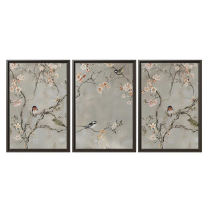 Small songbirds among pink and cream blossoms, green leaves and delicate branches on gray 3 piece framed canvas wall art viewed straight on