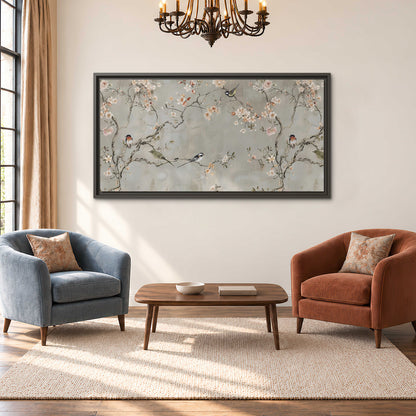Small songbirds among pink and cream blossoms, green leaves and delicate branches on gray single framed canvas wall art styled in an interior