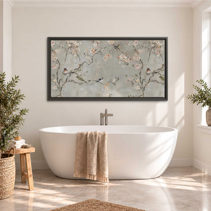 Small songbirds among pink and cream blossoms, green leaves and delicate branches on gray single framed canvas wall art styled in an interior