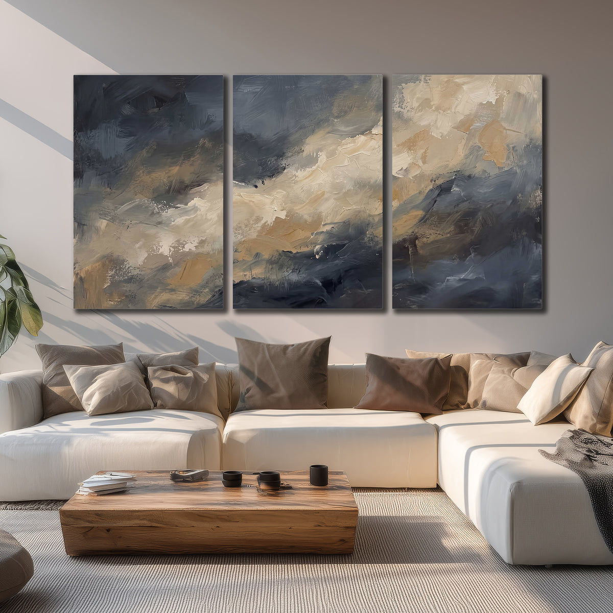 Sweeping charcoal and cream painted clouds with warm gold tones 3 piece canvas wall art displayed in a living room
