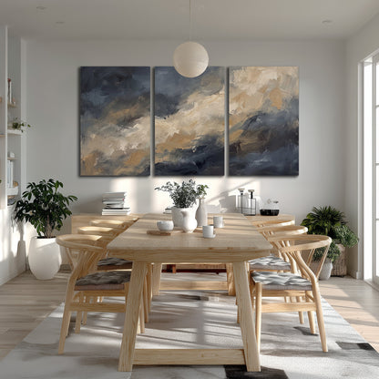 Sweeping charcoal and cream painted clouds with warm gold tones 3 piece canvas wall art room and product view