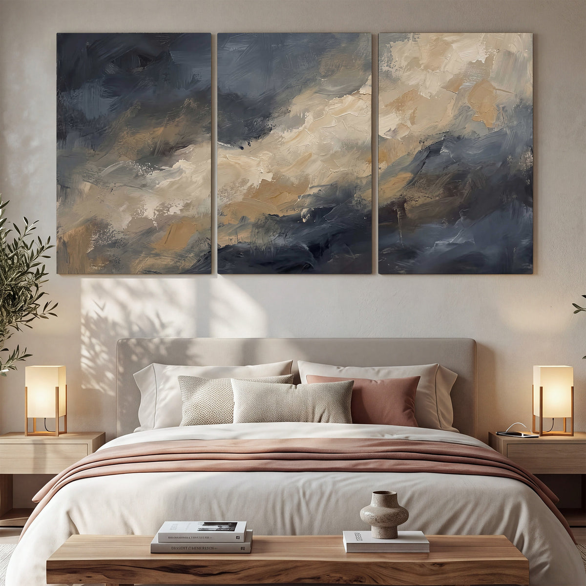 Sweeping charcoal and cream painted clouds with warm gold tones 3 piece canvas wall art displayed in a bedroom