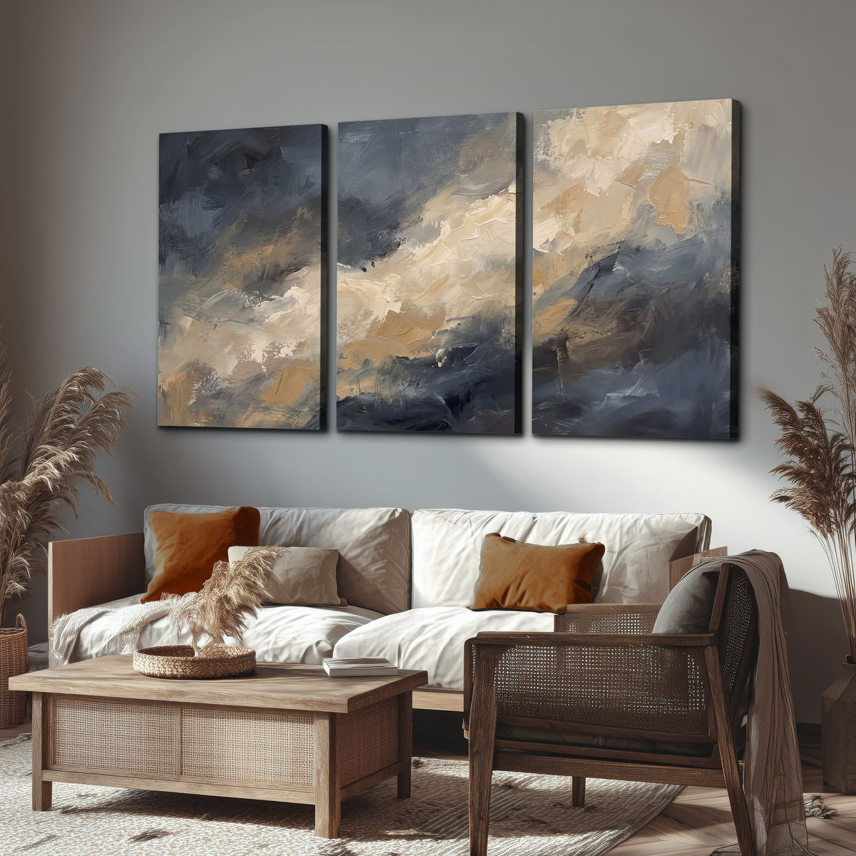 Sweeping charcoal and cream painted clouds with warm gold tones 3 piece canvas wall art displayed in a rustic living room