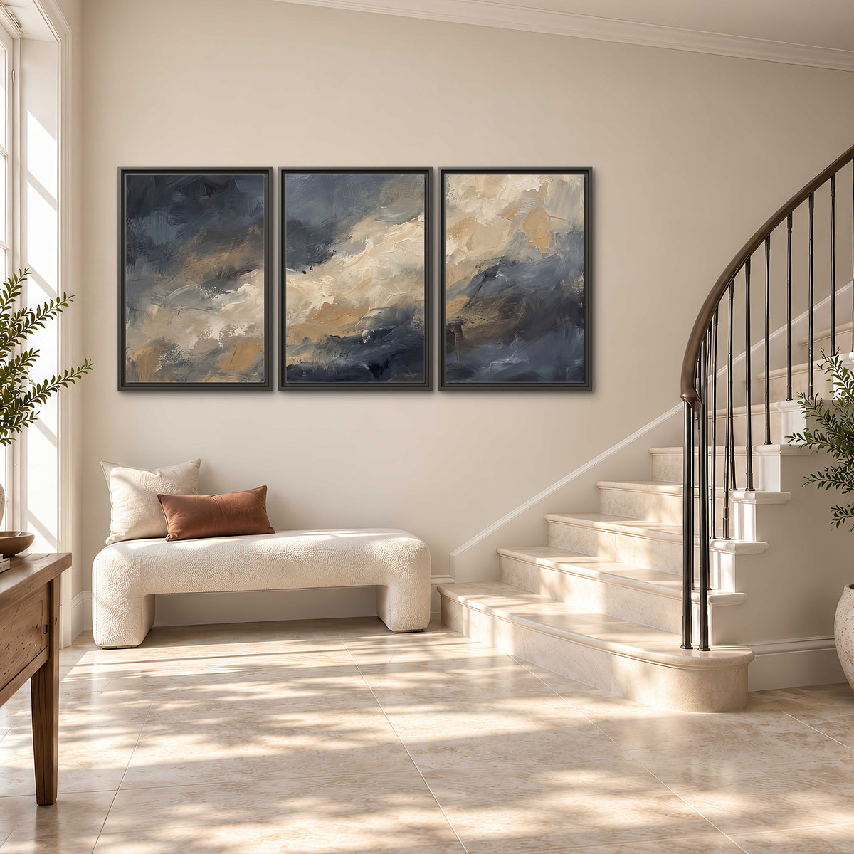 Sweeping charcoal and cream painted clouds with warm gold tones 3 piece framed canvas wall art styled in an interior