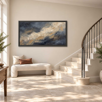 Sweeping charcoal and cream painted clouds with warm gold tones single framed canvas wall art styled in an interior