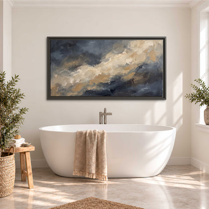 Sweeping charcoal and cream painted clouds with warm gold tones single framed canvas wall art styled in an interior