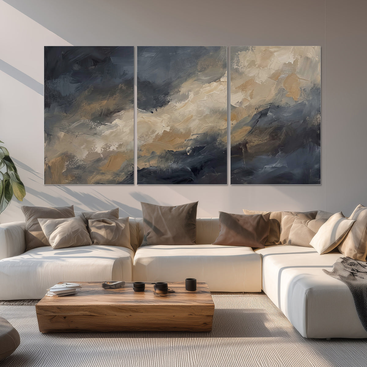 Sweeping charcoal and cream painted clouds with warm gold tones set of 3 poster prints displayed in a living room