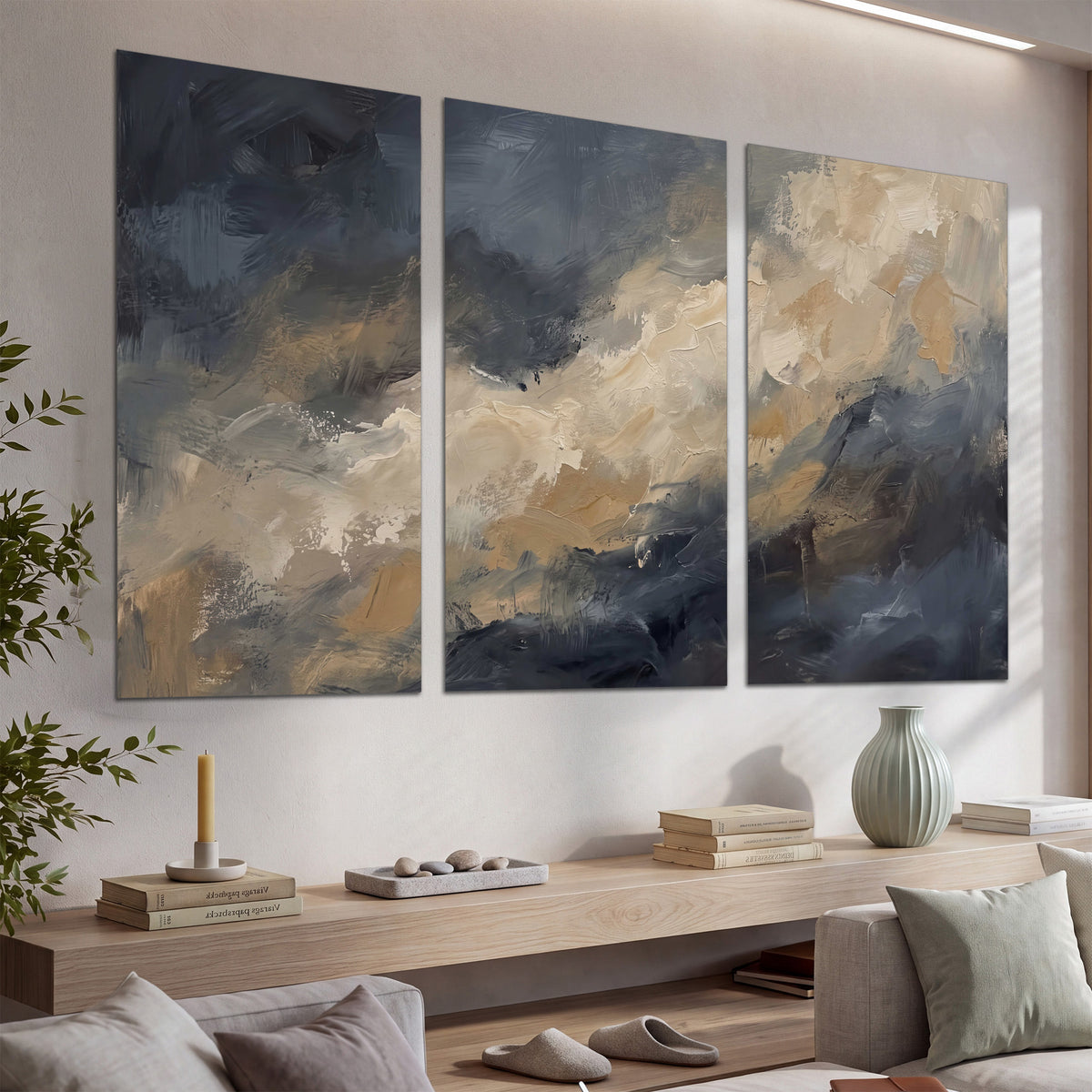 Sweeping charcoal and cream painted clouds with warm gold tones set of 3 poster prints displayed in a console