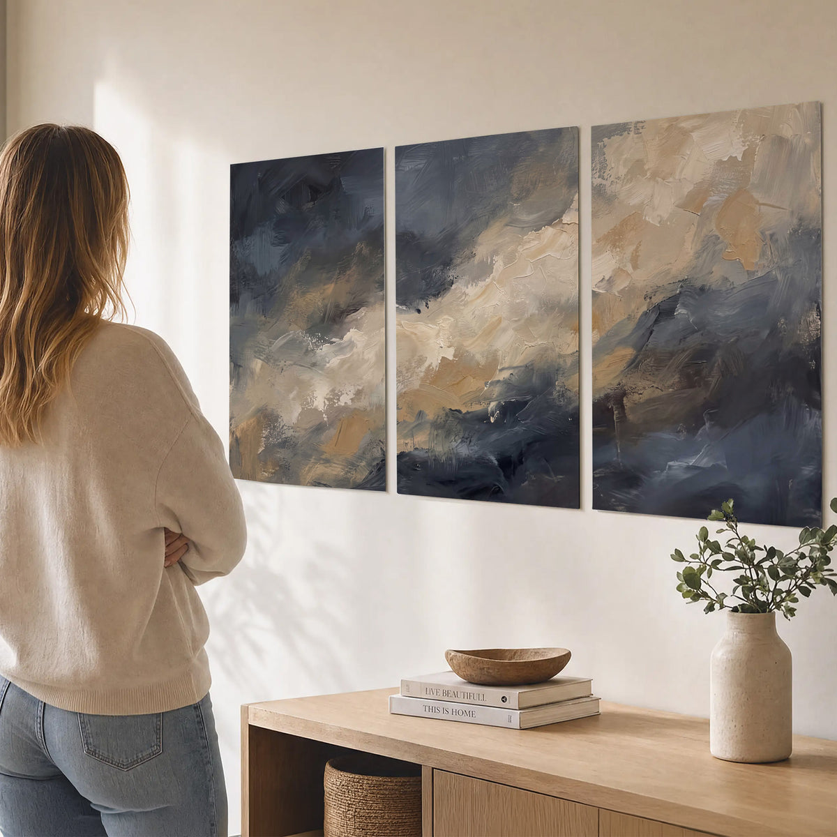 Sweeping charcoal and cream painted clouds with warm gold tones set of 3 poster prints three panel arrangement on a wall