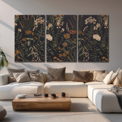 Small cream and rust flowers on a dark botanical background 3 piece canvas wall art displayed in a living room