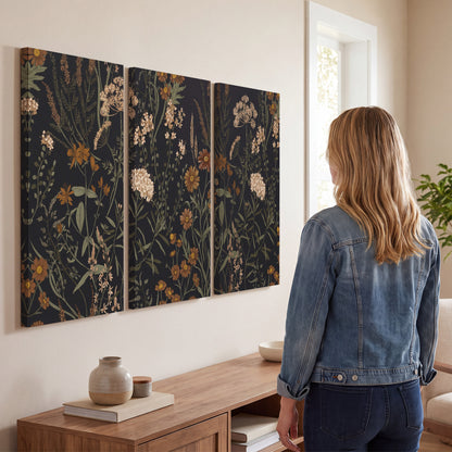 Small cream and rust flowers on a dark botanical background 3 piece canvas wall art three panel arrangement on a wall