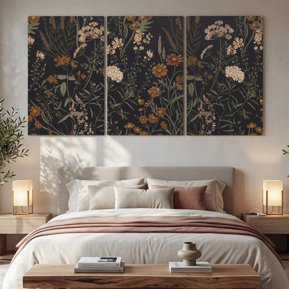 Small cream and rust flowers on a dark botanical background 3 piece canvas wall art displayed in a bedroom