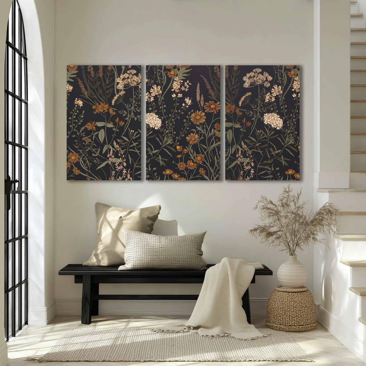Small cream and rust flowers on a dark botanical background 3 piece canvas wall art displayed in a entryway