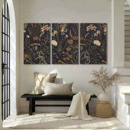 Small cream and rust flowers on a dark botanical background 3 piece canvas wall art displayed in a entryway