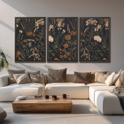 Small cream and rust flowers on a dark botanical background 3 piece framed canvas wall art displayed in a living room