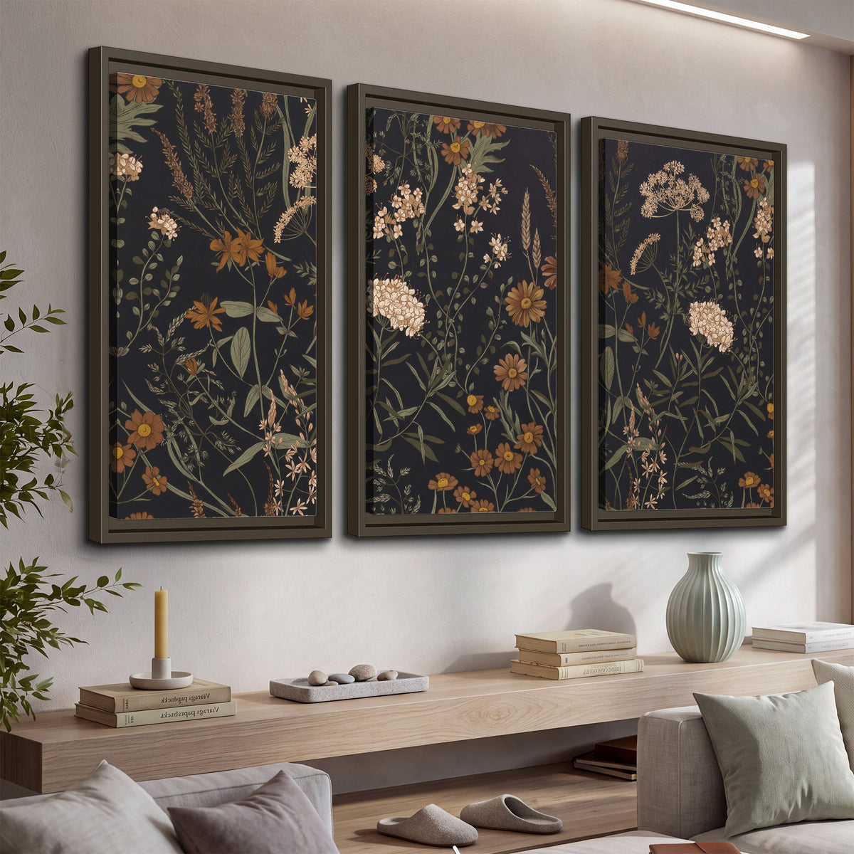 Small cream and rust flowers on a dark botanical background 3 piece framed canvas wall art displayed in a console