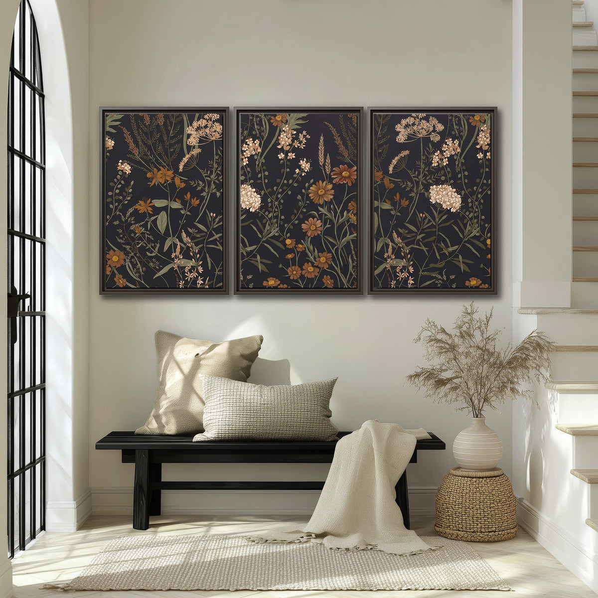 Small cream and rust flowers on a dark botanical background 3 piece framed canvas wall art displayed in a entryway