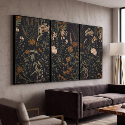 Small cream and rust flowers on a dark botanical background 3 piece framed canvas wall art displayed in a modern living room