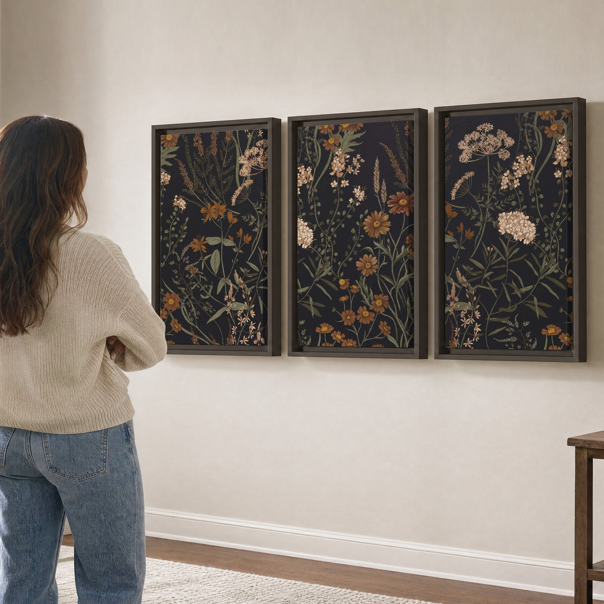 Small cream and rust flowers on a dark botanical background 3 piece framed canvas wall art three panel arrangement on a wall