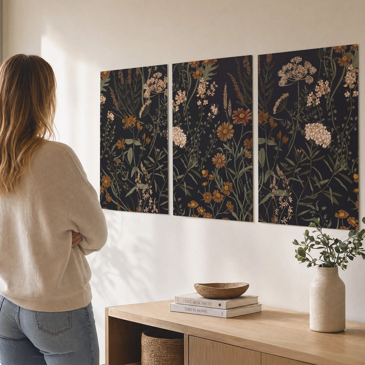 Small cream and rust flowers on a dark botanical background set of 3 poster prints three panel arrangement on a wall