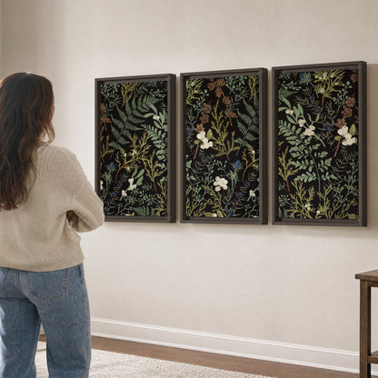 Fine green ferns and cream flowers on a black background 3 piece framed canvas wall art three panel arrangement on a wall