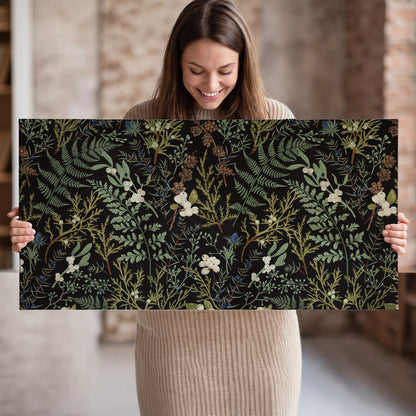 Fine green ferns and cream flowers on a black background single canvas wall art held in hands